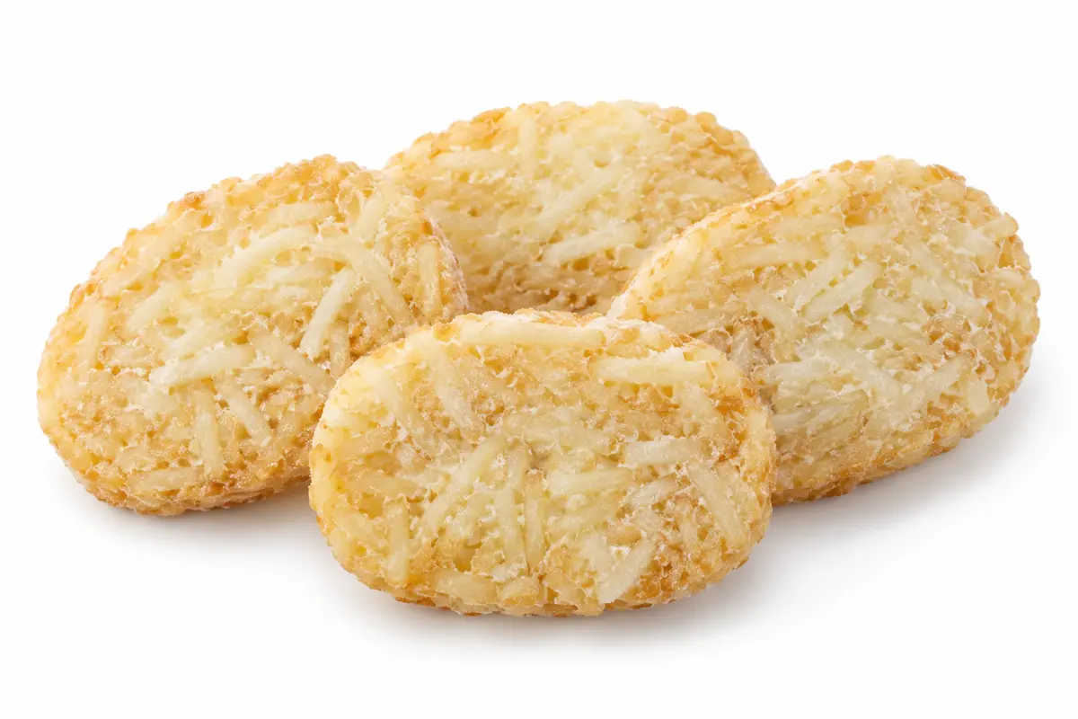 Frozen shredded potato hash brown patties with light frost