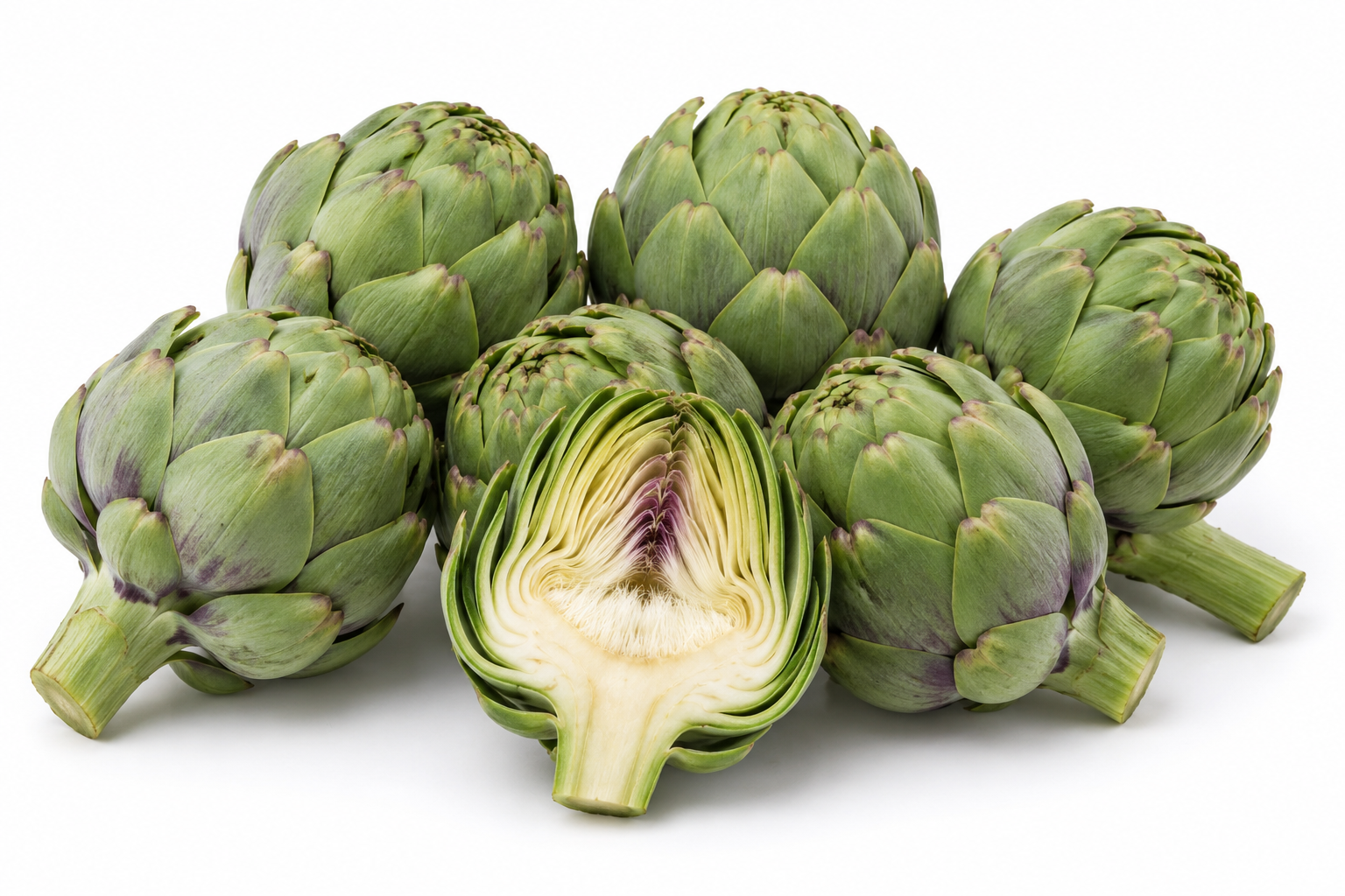 Fresh Egyptian globe artichokes with a cut artichoke showing the heart